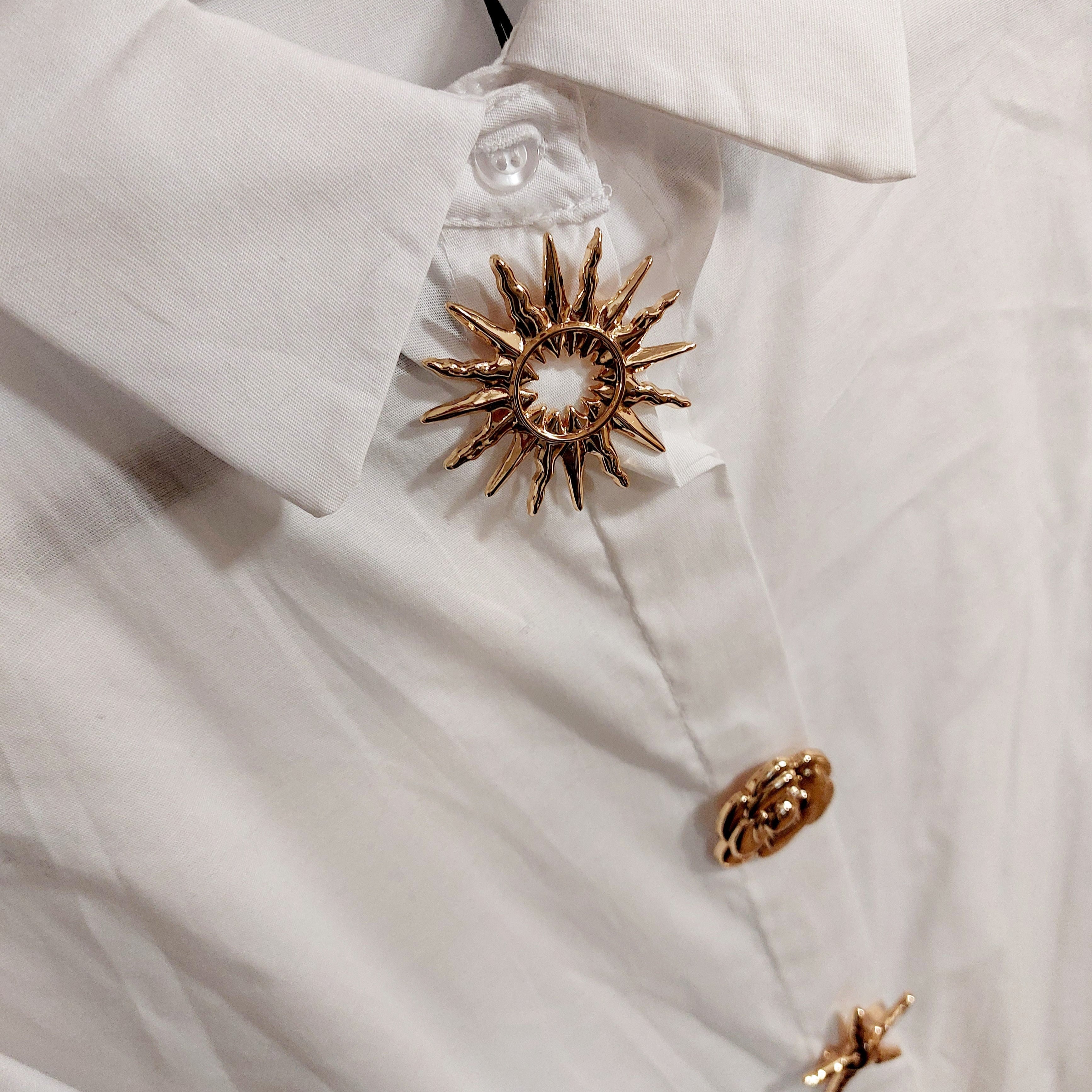 Détail broches dorées chemise MIKI blanche - Accessoires dorés amovibles soleil, rose et étoile
