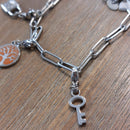 charm ou breloque avec un petit fermoir  ajouter un bracelet anneaux rectangle argent en accumulation personnalisé avec un charm arbre de vie, un charm cadenas et un charm petite clé argent  en acier inoxydable sur sausset les pins