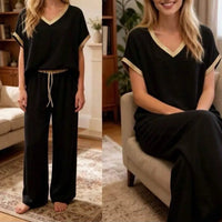 Ensemble Eddy noir porté – top col V manches courtes et pantalon droit, finitions dorées, taille unique 36-44