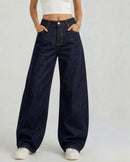 Jean ballon Liam denim brut indigo foncé face – coupe taille haute ample, coutures camel contrastantes, poches avant, porté avec crop top blanc
