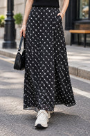 Jupe longue satinée à pois Alicia noire, taille élastique, coupe fluide
