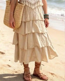 Jupe longue Emma ecru portée avec sandales à lacets sur une plage de sable — voile coton volants taille élastique — look bohème chic été — ineva
