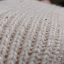 Détail des sequins délicats sur les mitaines longues Lume en maille serrée