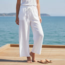 Pantalon Roman en gaze de coton coloris blanc, il est élastiqué à la taille et de coupe large 
