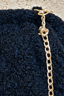 Détail du tissu aspect laine bouillie du sac Sole noir
