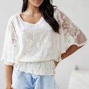Top crochet résille Louise blanc porté sur un short en jean — col V manches poncho resserré à la taille — look bohème chic été — ineva
