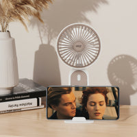 Ventilateur à main Zeph posé sur son support - smartphone calé sur la base - mode mains libres bureau - ineva
