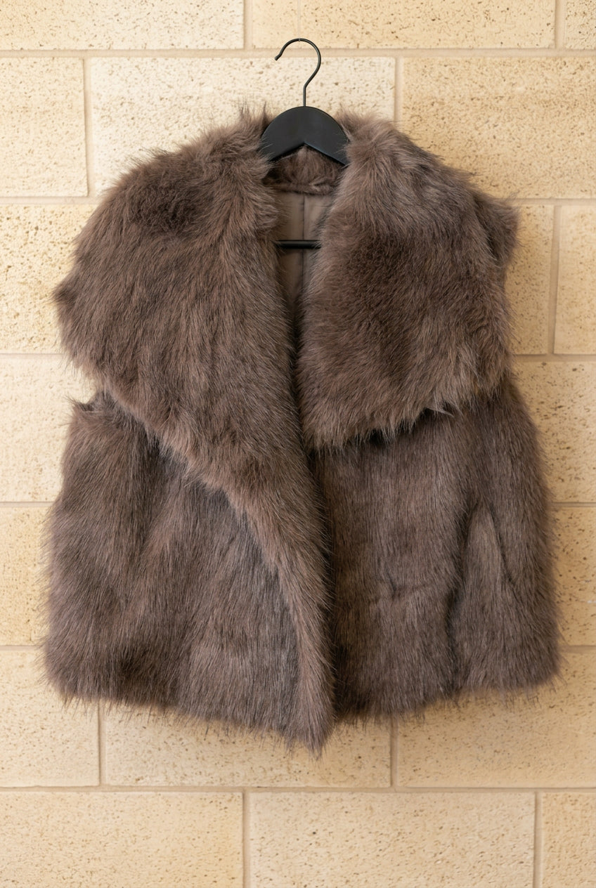 Gilet sans manches Loren choco en fausse fourrure à poils longs, présenté de face sur cintre
